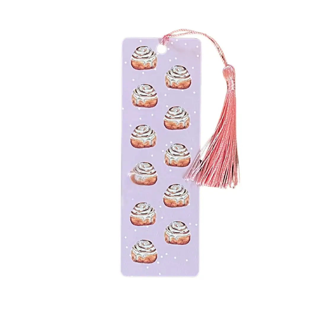 Purple bookmark with cinnamon roll illustrations and a pink tassel