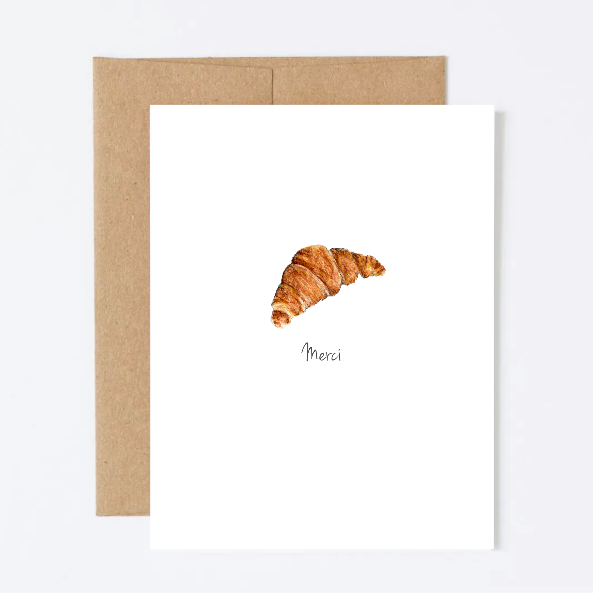 Framed artwork of a croissant with 'Merci' on a white background