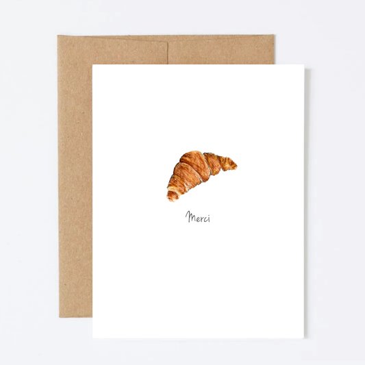 Framed artwork of a croissant with 'Merci' on a white background